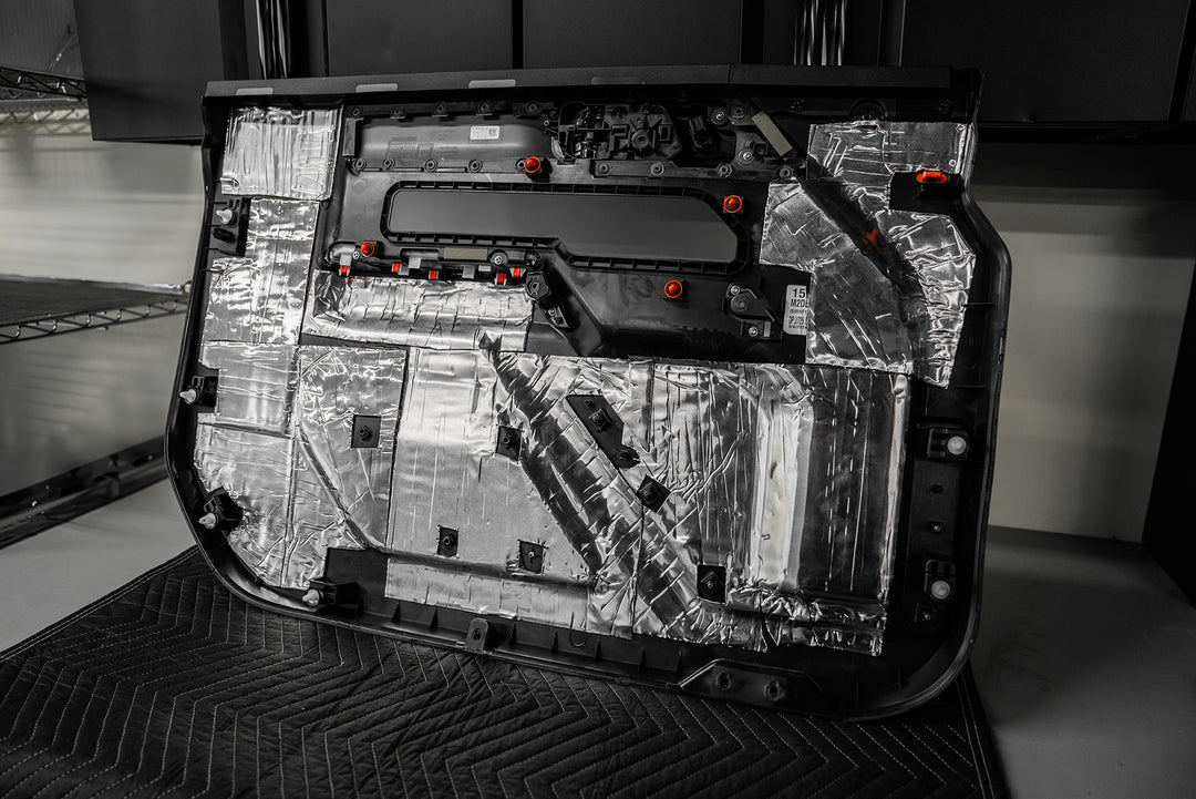 ResoNix Mega CLD Squares sound deadening mats applied to the back of a cars door panel