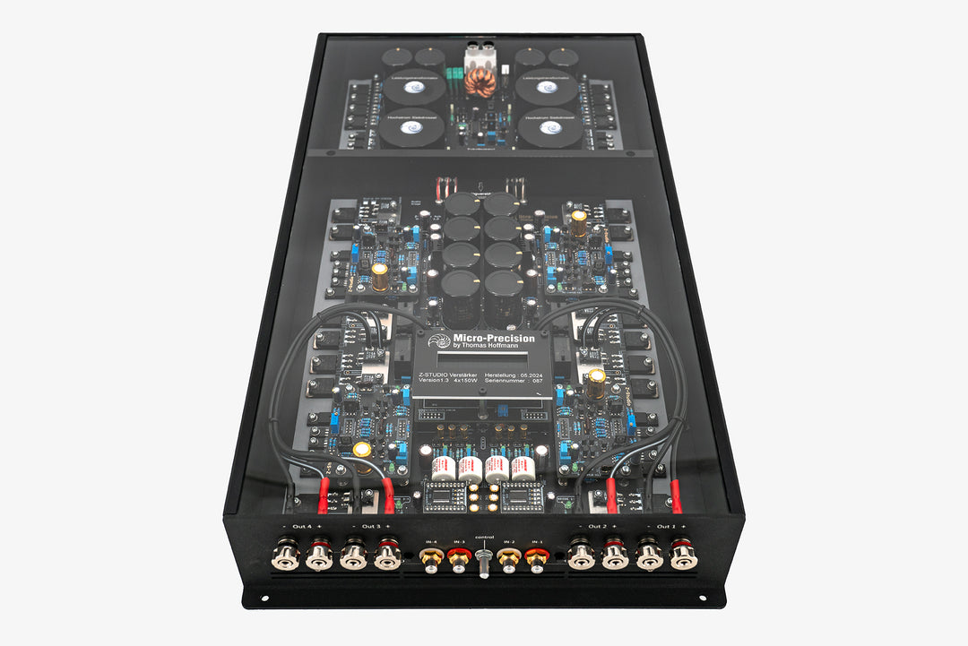 A Micro Precision Z-Studio 4c 4-channel car audio amplifier with visible electronic components, circuitry, and connectors on the top surface.