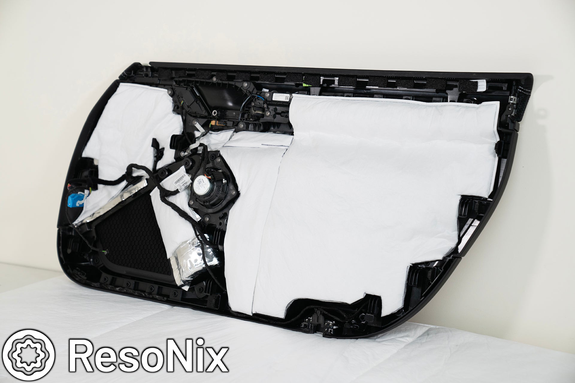 ResoNix Fiber Mat sound absorber for vehicles applied to the back of a Porsche 911 GT3 door panel.