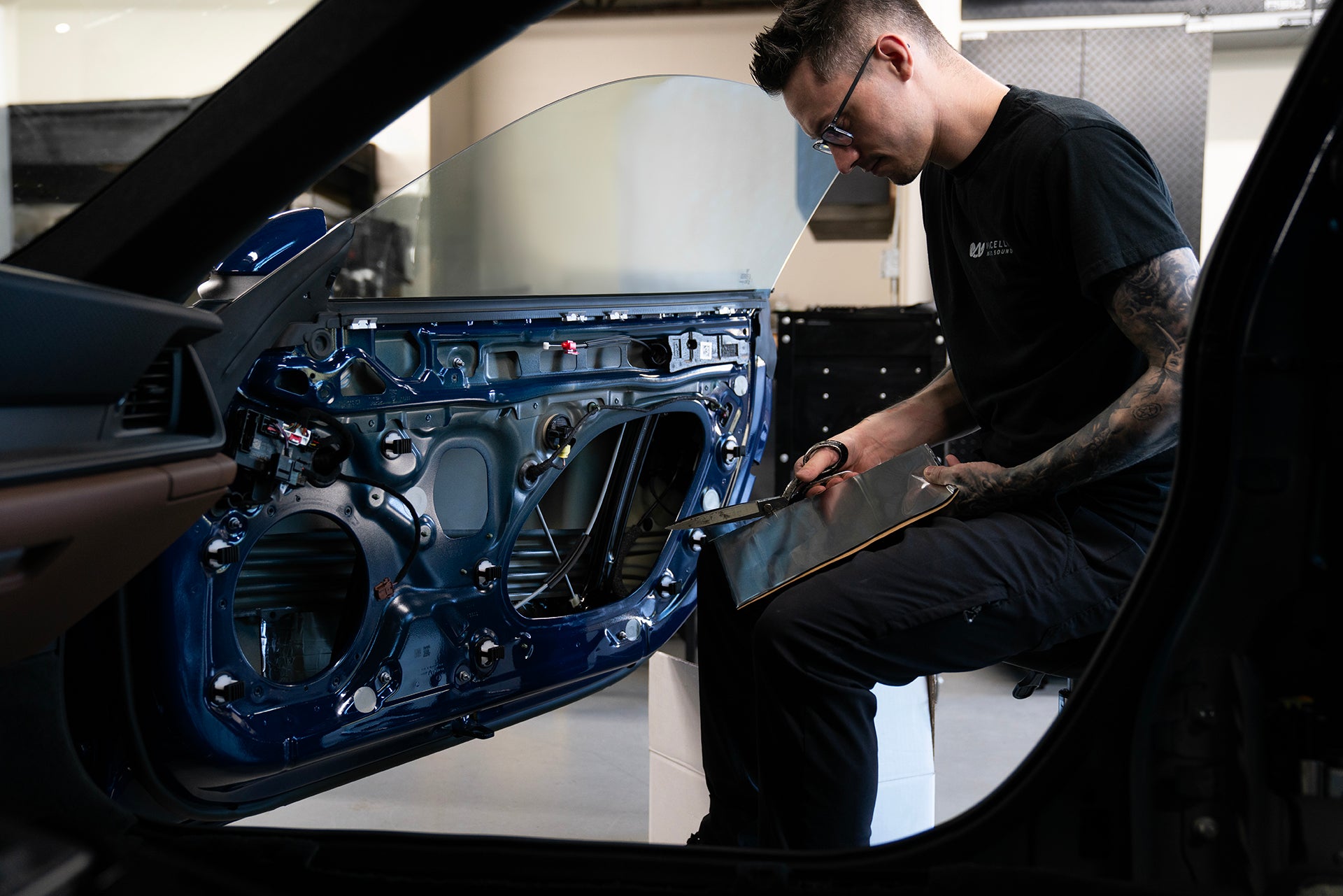Nick Apicella installing ResoNix CLD Squares Automotive Sound Deadening Material into the door of a Porsche 911 GT3 Touring