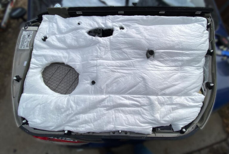 ResoNix Fiber Mat sound absorber for automobiles applied to the back of a door panel.