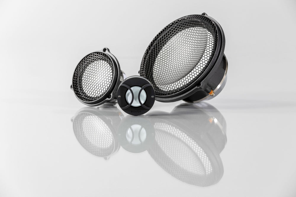 3-way set of Automotive Accuton Ceramic speakers with white color cones displayed on a reflective surface