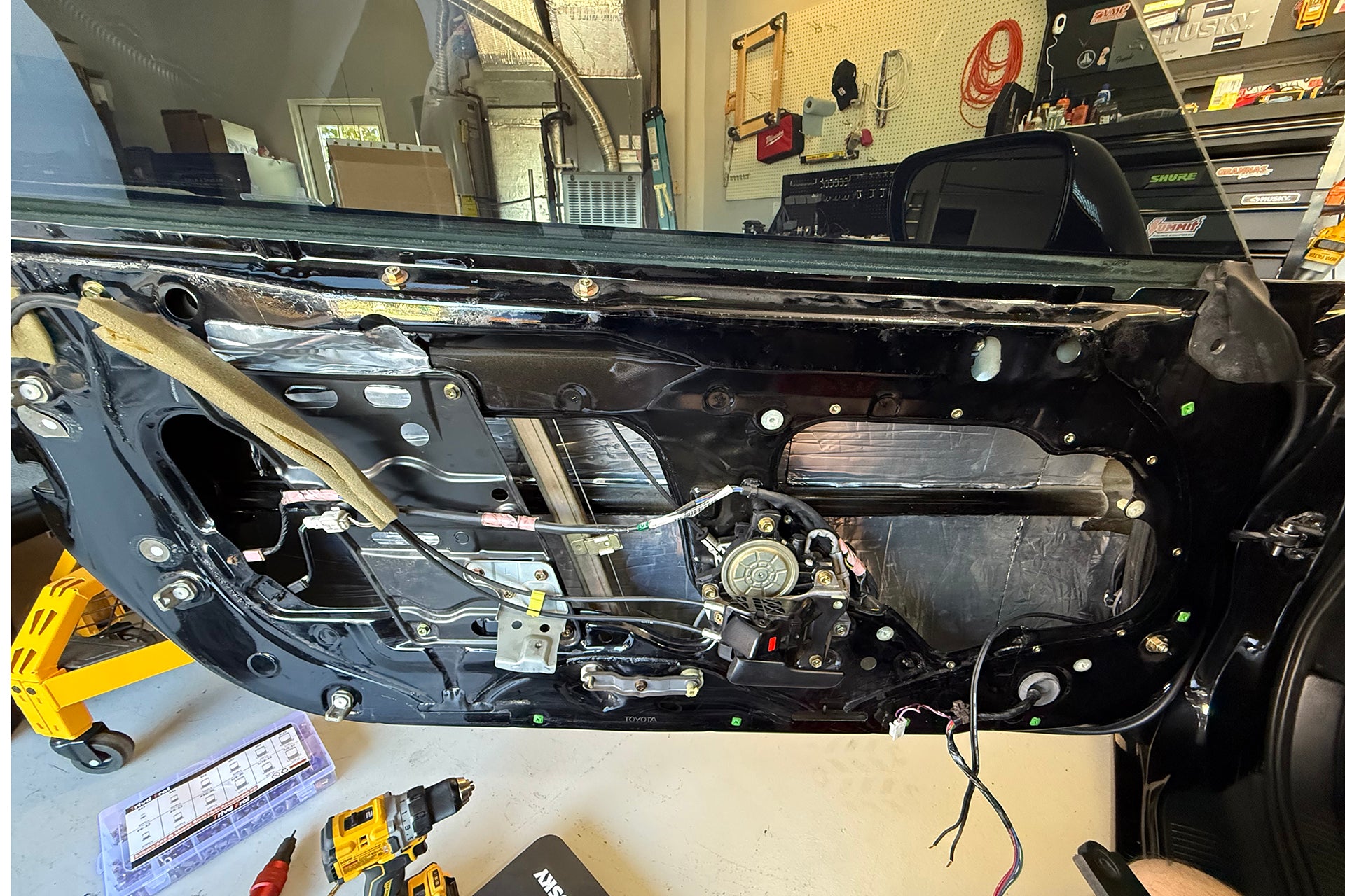 Toyota Supra door with ResoNix CLD Squares automobile sound deadening mat applied to the outer door skin