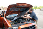 car hood being lined by someone with ResoNix Fiber Mat Silver automotive sound insulation and heat insulation material