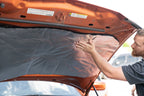 car hood being lined with ResoNix Fiber Mat Silver sound and heat insulation material