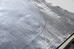 close up of ResoNix Fiber Mat Silver automotive sound and heat  insulation material with drawn on cut pattern