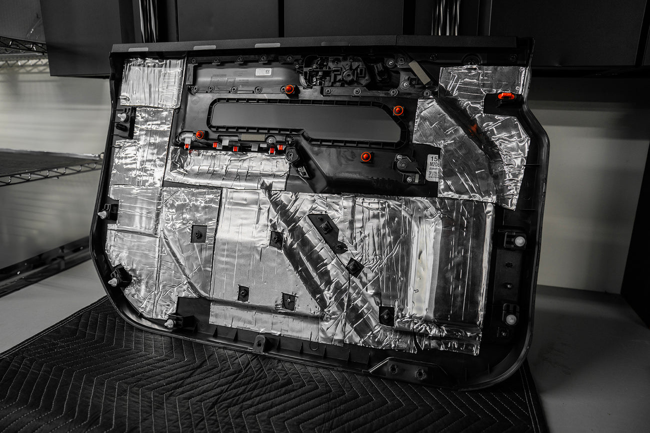 back side of a door panel that is treated with ResoNix CLD Squares automobile sound mats