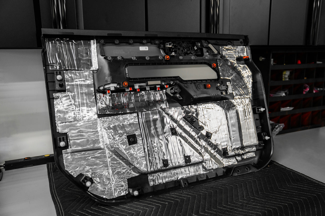 back side of a door panel that is treated with ResoNix CLD Squares automobile sound mats