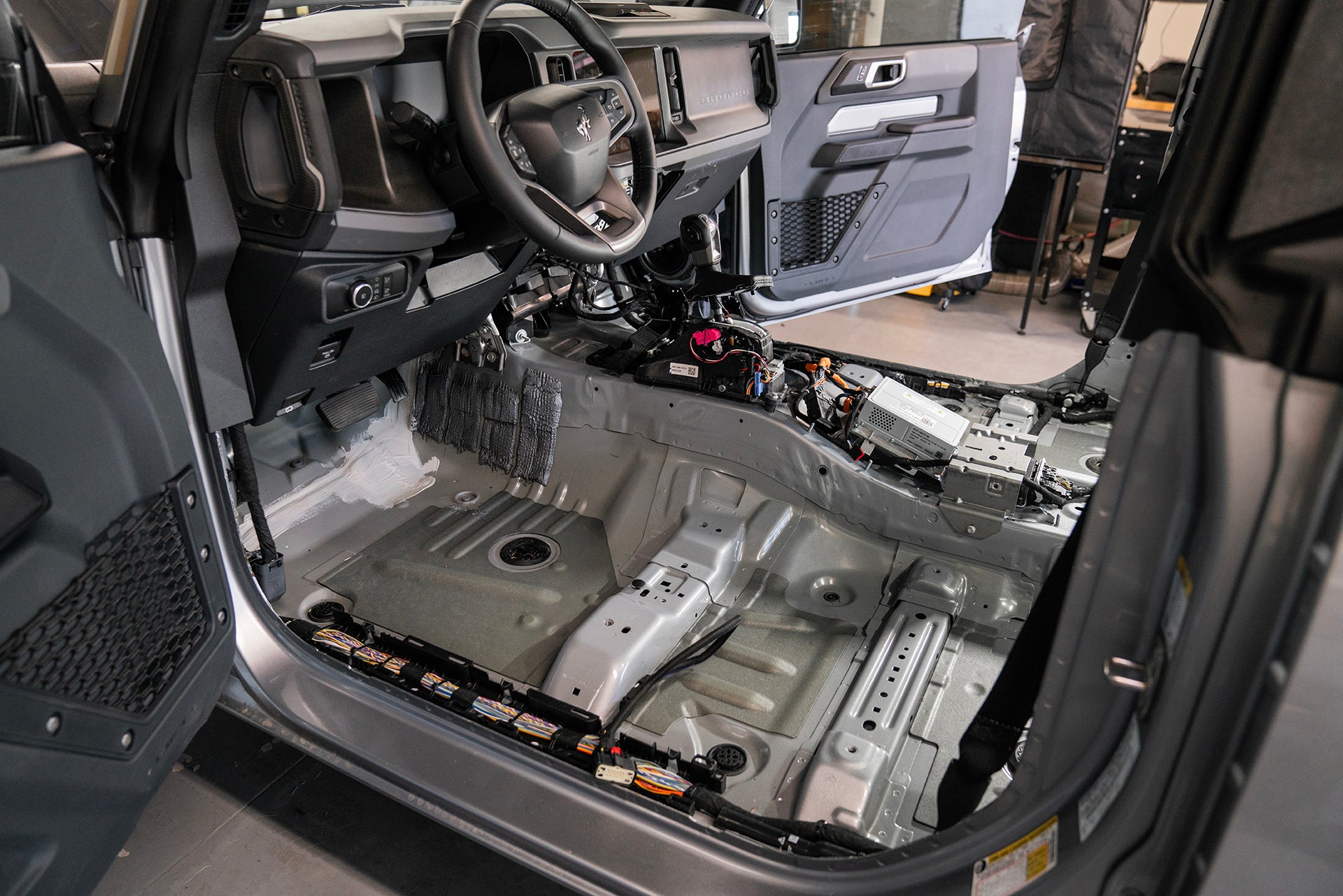 Ford Bronco front driver side floor with seat and carpet removed