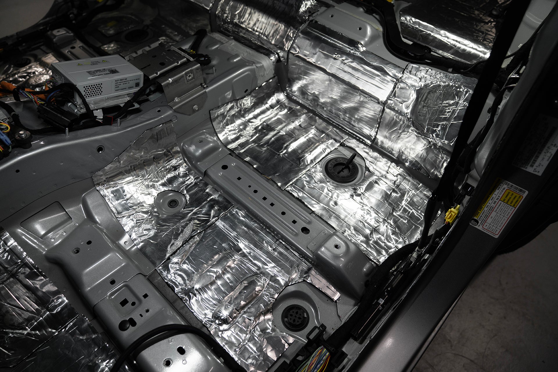 ResoNix Sound Solutions CLD Squares Sound Deadener installed into the front drivers side floor of a Ford Bronco