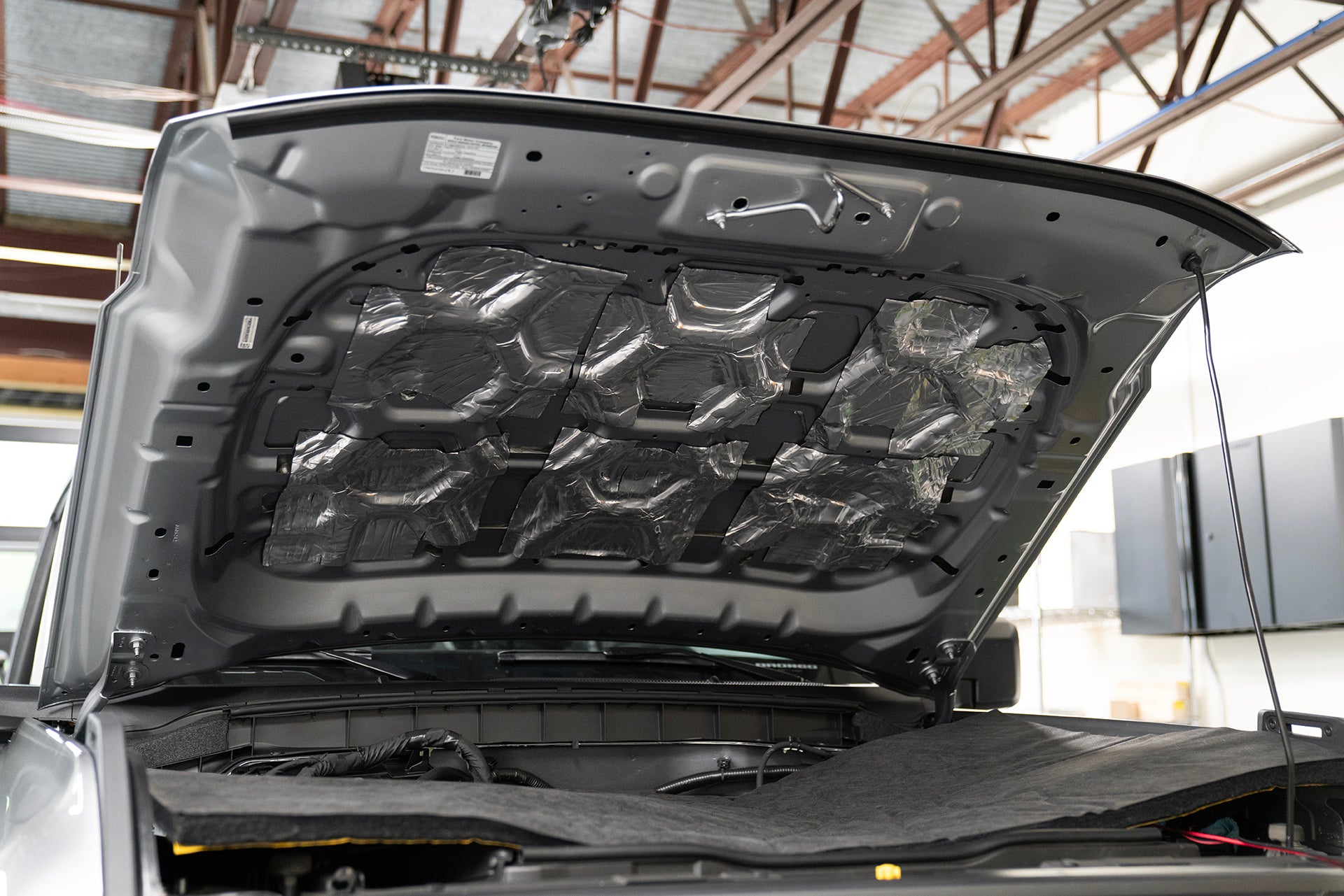 underside of Ford Bronco hood that is treated with ResoNix CLD Squares sound deadening material