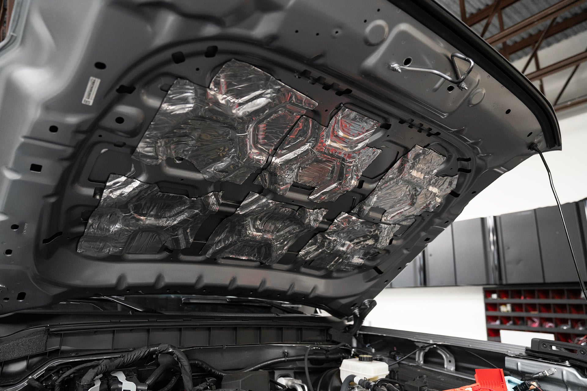 underside of Ford Bronco hood that is treated with ResoNix CLD Squares sound deadening material