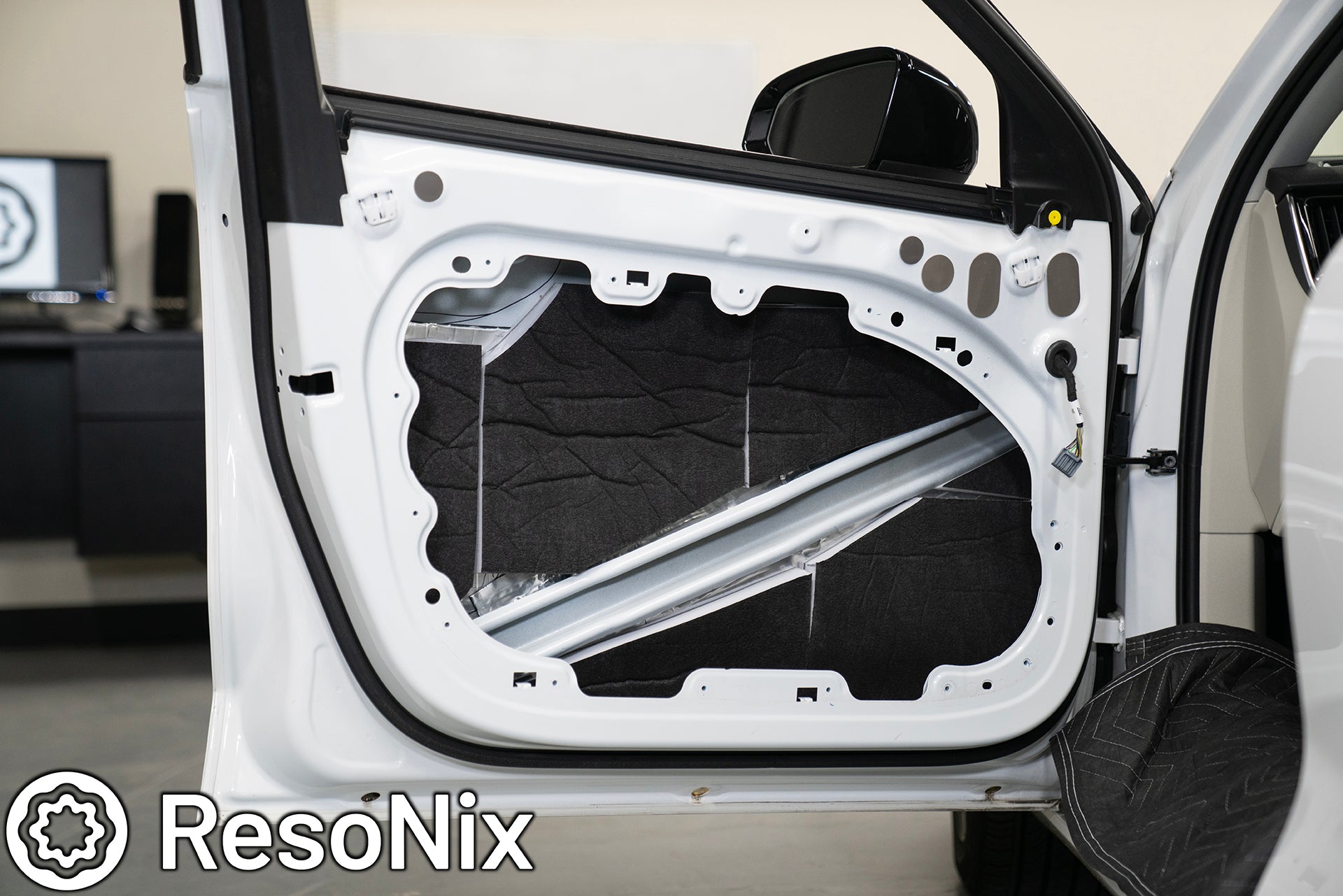 Car door with ResoNix Guardian soundproofing and CLD Squares sound deadening mats installed
