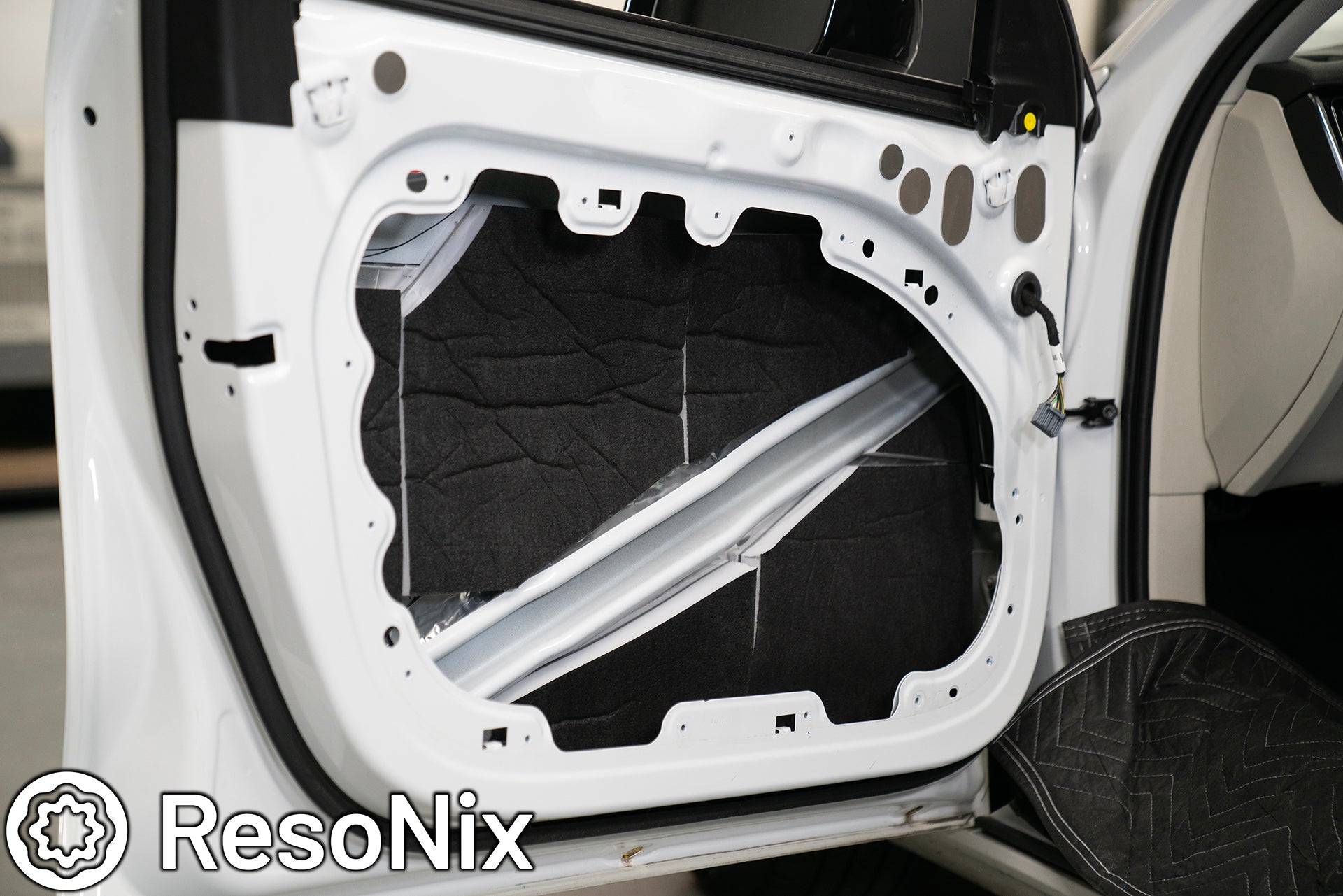 Volvo S60 R Design door with ResoNix Guardian Hydrophobic Melamine and MLV Material applied to the outer door skin to absorb the speakers rear wave for distortion and resonance reduction, and to absorb and block outside road, wind, and tire noise
