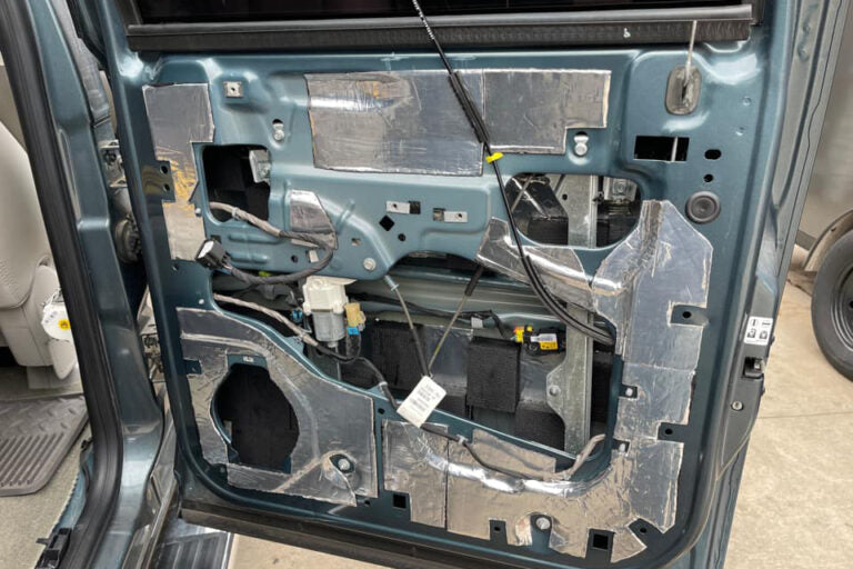 Car door interior with speaker and ResoNix CLD Squares soundproofing material