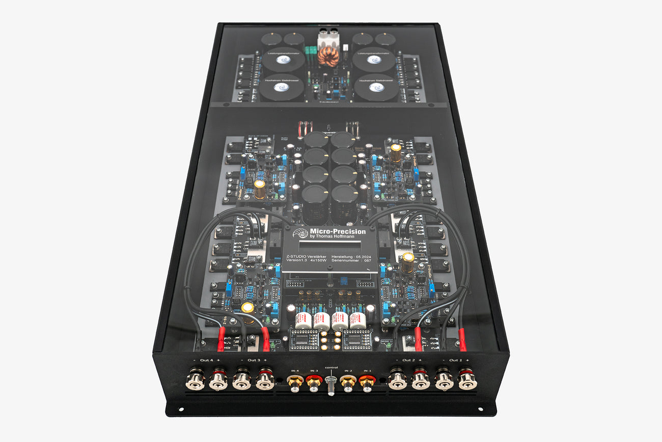 A Micro Precision Z-Studio 4c 4-channel car audio amplifier with visible electronic components, circuitry, and connectors on the top surface.