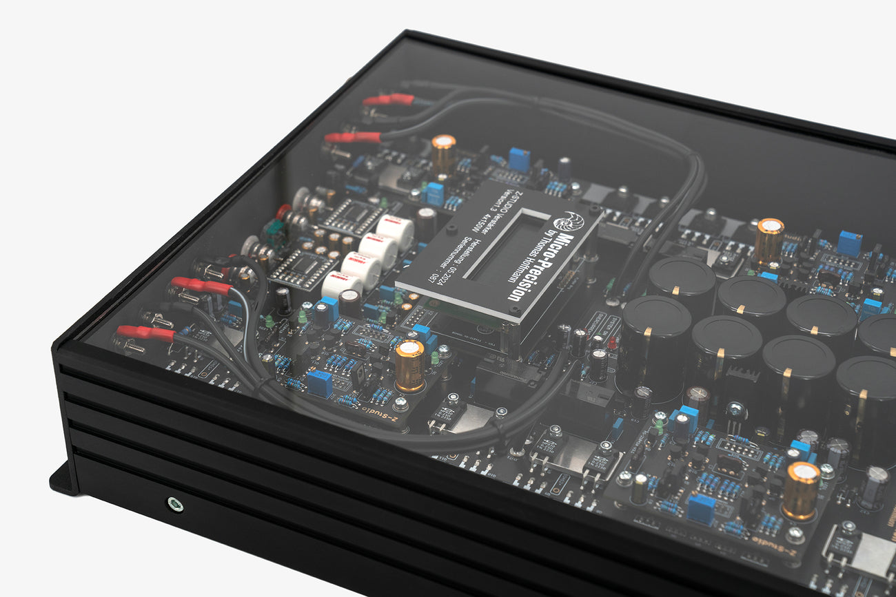 A close up shot of a Micro Precision Z-Studio 4c 4-channel car audio amplifier with visible electronic components, circuitry, and connectors on the top surface.
