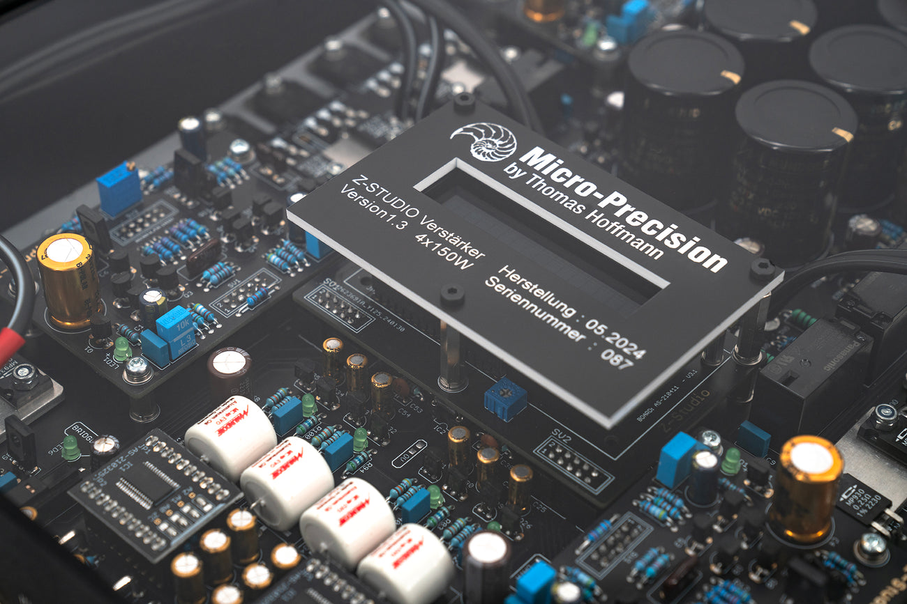 Close up of the display panel for the A Micro Precision Z-Studio 4c 4-channel car audio amplifier with visible electronic components, circuitry, and connectors on the top surface.