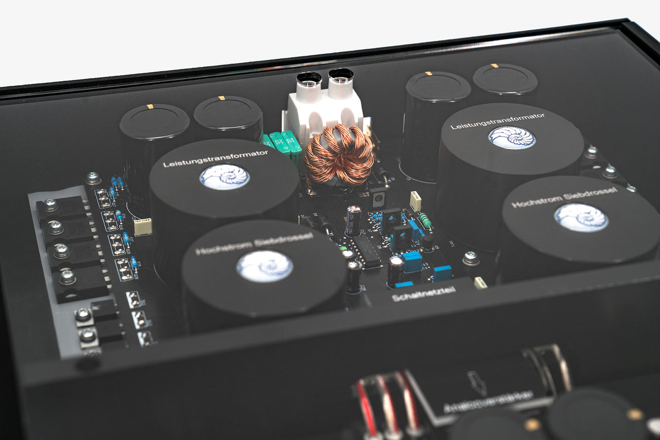 A close up shot of a Micro Precision Z-Studio 4c 4-channel car audio amplifier with visible electronic components, circuitry, and connectors on the top surface.