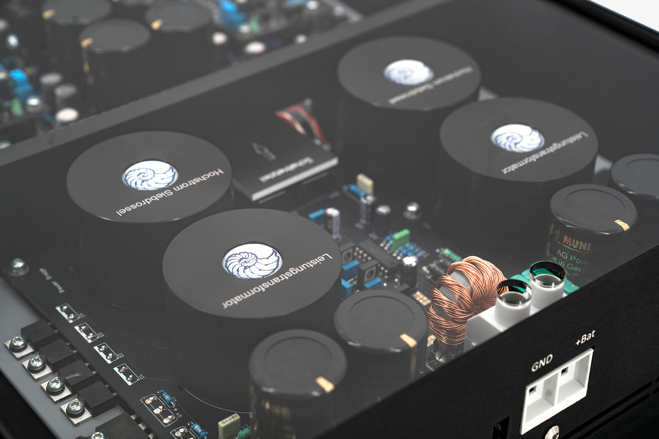 A close up shot of a Micro Precision Z-Studio 4c 4-channel car audio amplifier with visible electronic components, circuitry, and connectors on the top surface.