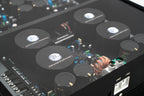 A close up shot of a Micro Precision Z-Studio 4c 4-channel car audio amplifier with visible electronic components, circuitry, and connectors on the top surface.