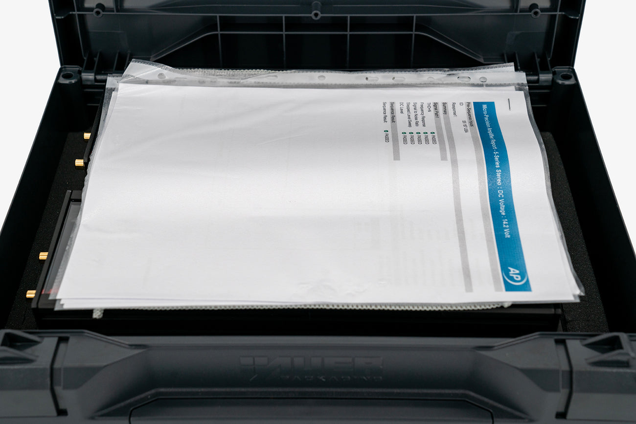 a pair of Micro Precision 5-Series two channel high end car audio amplifiers in their shipping case with the spec sheet