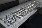 Line up of Micro Precision Z-Studio Tweeters, Midranges, and Midbass drivers on a production table