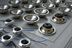 production setting work table showing multiple Micro Precision Z-Studio tweeters, midranges, and midbass speakers