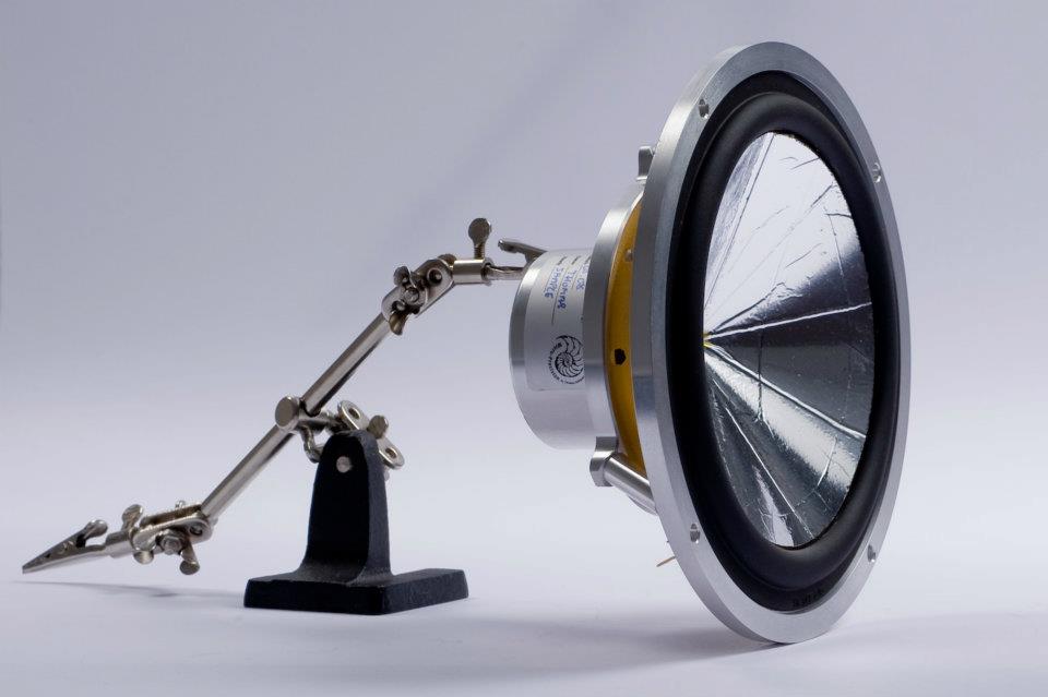 side angle showing the magnet, basket, cone, and speaker terminals of a Micro Precision Z-Studio 170 6.5" car audio midbass speakers being held up with soldering helping hands