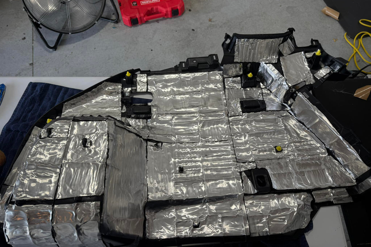 ResoNix CLD Squares sound deadener material installed onto the back of a cars interior plastic trim