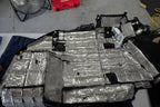 ResoNix CLD Squares sound deadening mats applied to the back of a vehicles trim panel