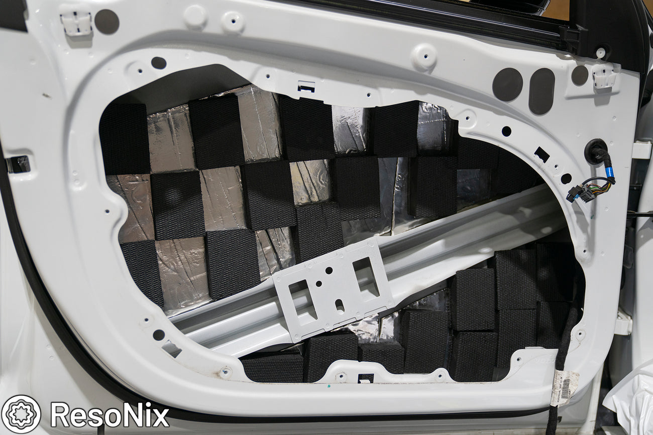 Car door that is treated with ResoNix CLD Squares sound deadening mat and Blackhole Tiles sound absorber