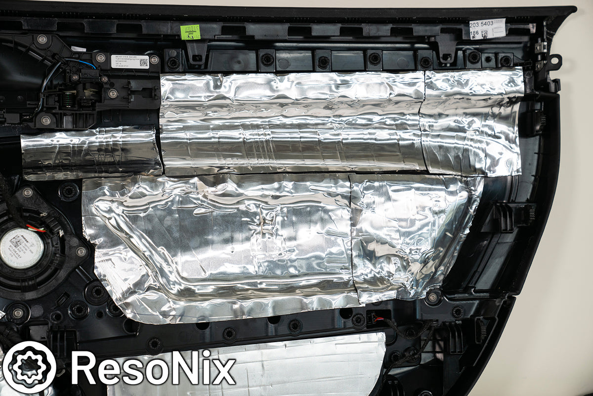 Close up of ResoNix CLD Squares sound deadening material installed onto the back of a door panel