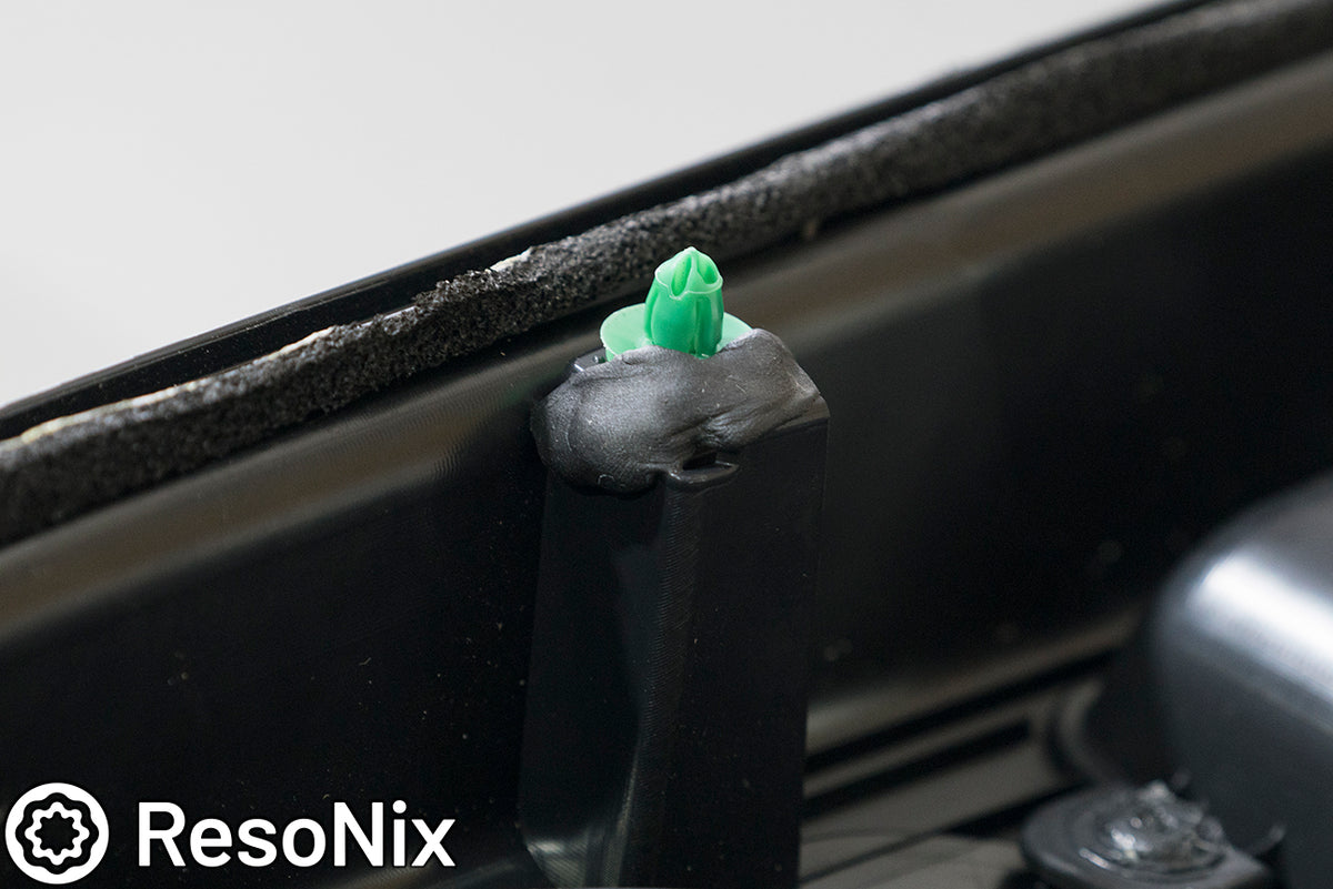 ResoNix Butyl Rope holding a door panel clip in place to prevent rattles and buzzes