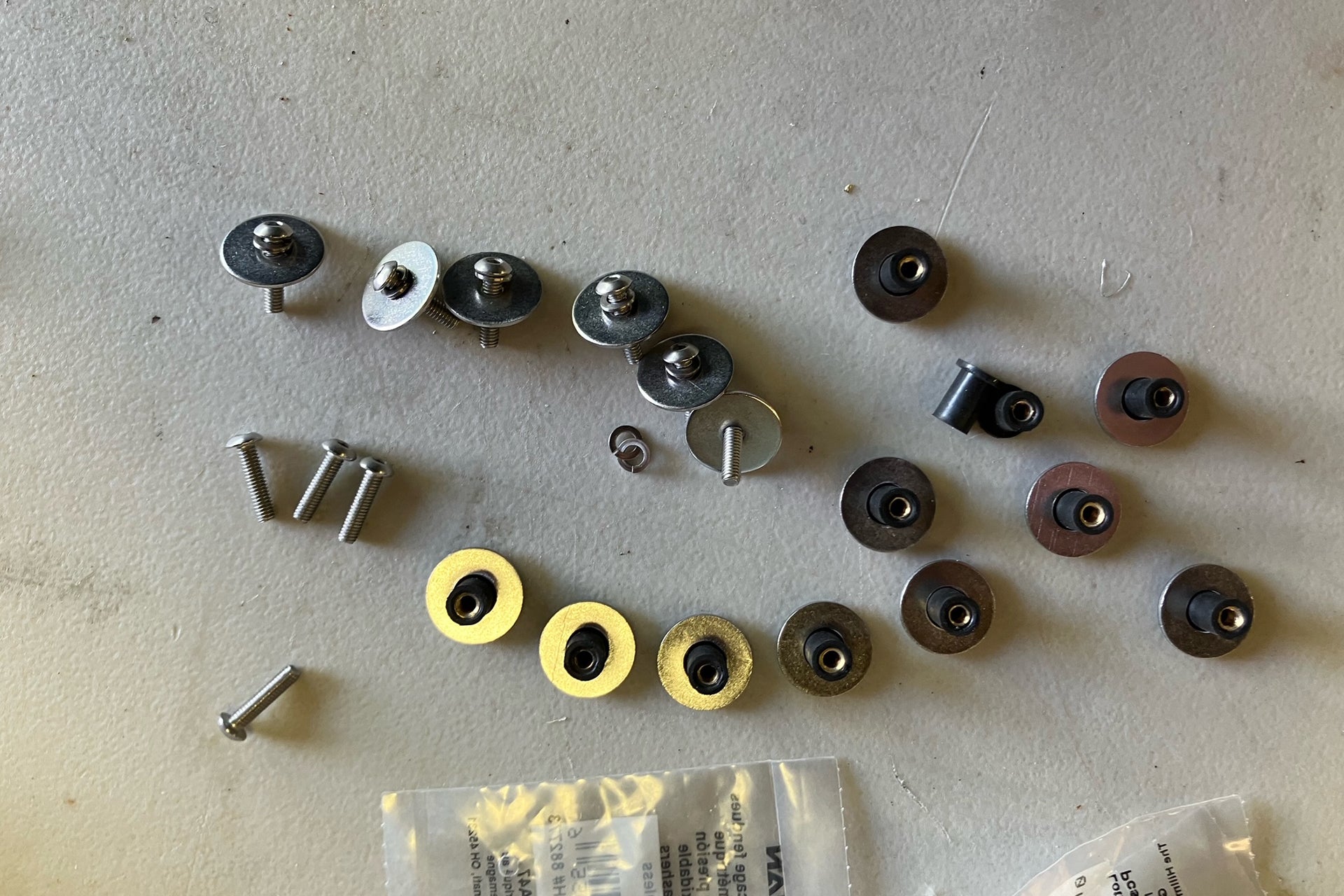 Well nuts, washers, and machine screws - hardware used to secure ResoNix Barrier to the inner door skin of a car door.