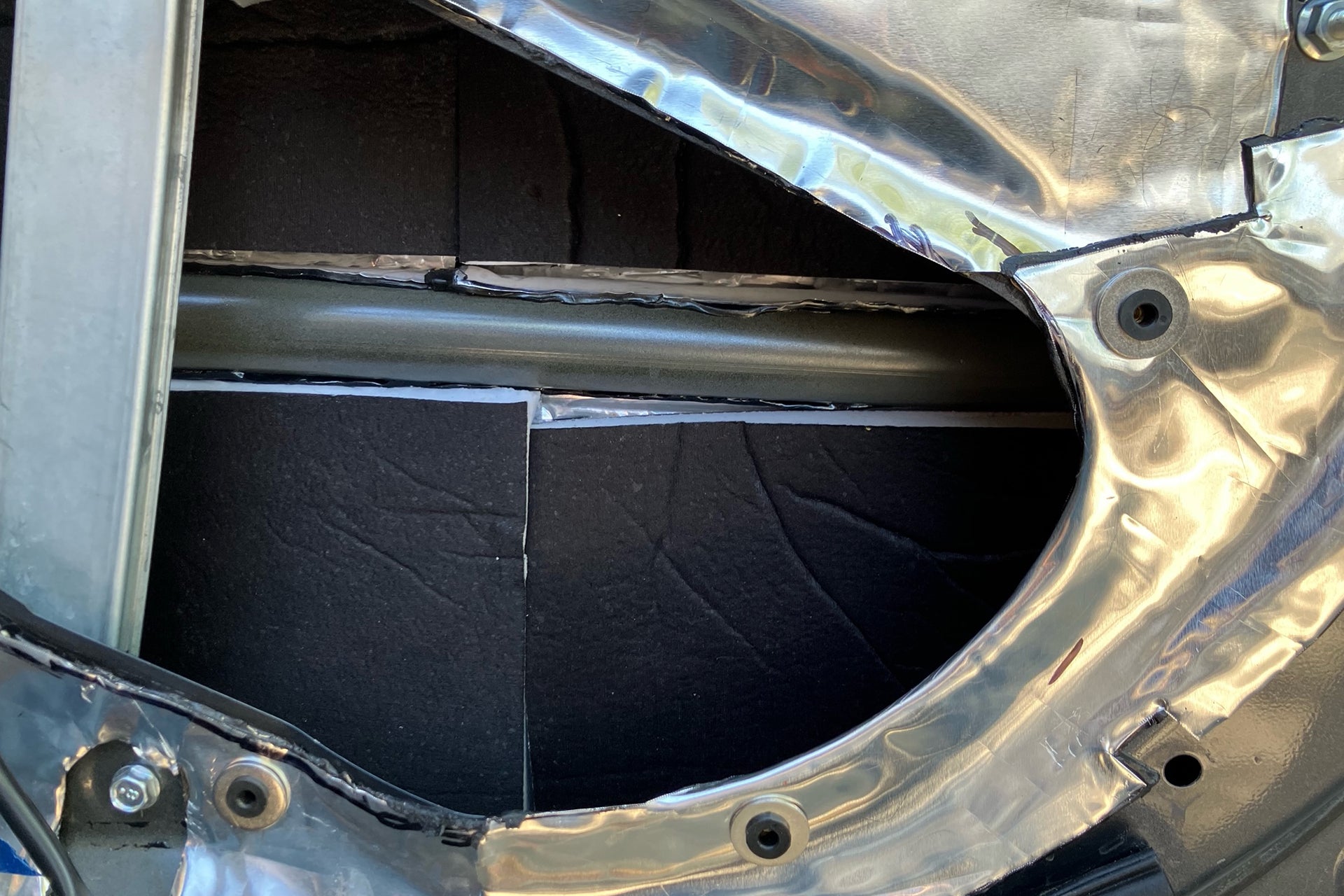 ResoNix Guardian automotive and marine sound absorber with MLV installed onto the outer door skin of a car door. The inner door skin is treated with ResoNix CLD Squares sound deadening material.