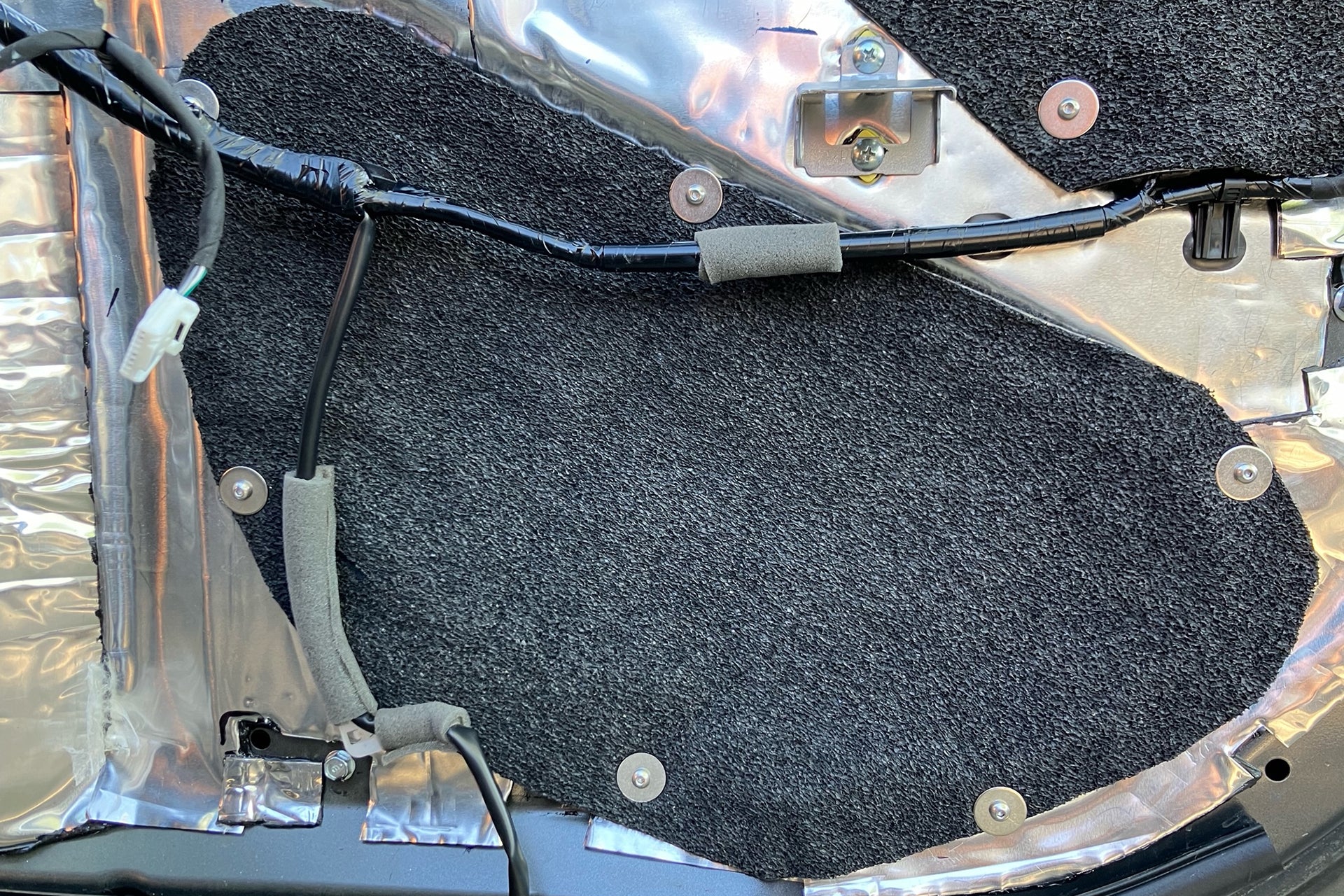 ResoNix Barrier being used to seal the access hole of an inner door skin, and is secured using machine screws, washers, and well nuts.