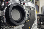 car door with door panel removed showing the inner door skin that is treated with ResoNix CLD Squares sound deadener and an Accuton Automotive C165AM 6.5" midbass speaker installed, and with ResoNix CCF Strips fast rings around them