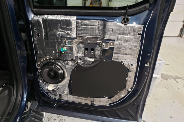 Car door interior with speaker and ResoNix CLD Squares soundproofing material