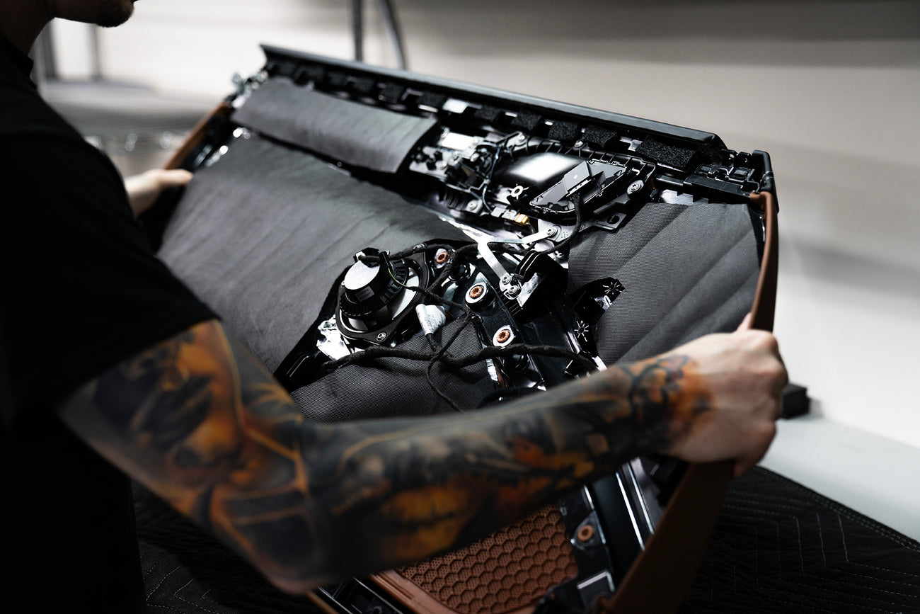 ResoNix Fiber Mat automotive sound insulation material installed onto the back of a car door panel being held by Nick Apicella of ResoNix