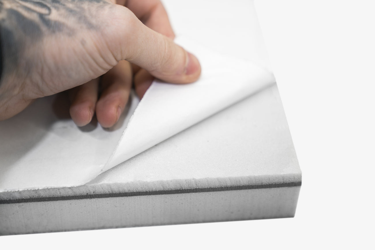 Back of ResoNix Guardian getting the backing paper peeled off to reveal the peel and stick adhesive layer