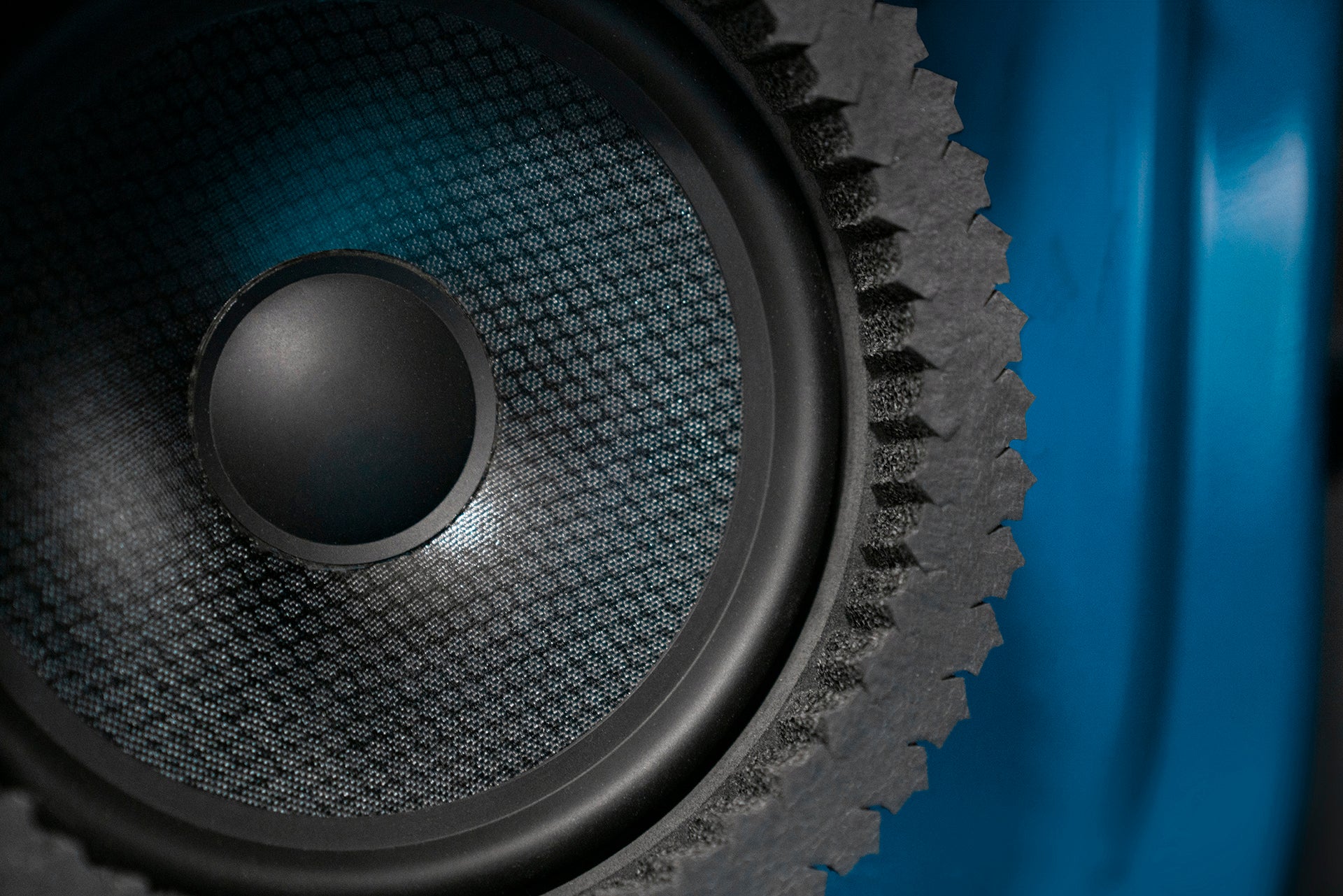 close up of a speaker installed into a car door with ResoNix CCF Strips fast rings installed around it