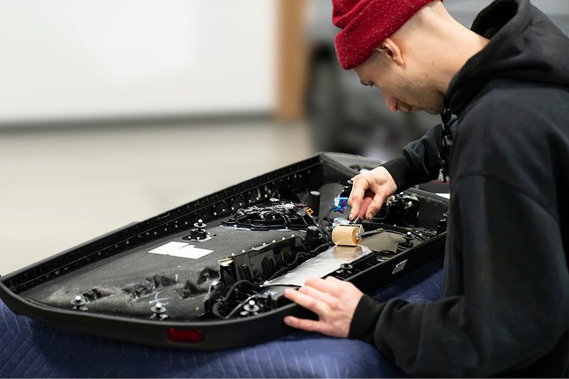 ResoNix Sound Solutions Man sound deadening a car door panel