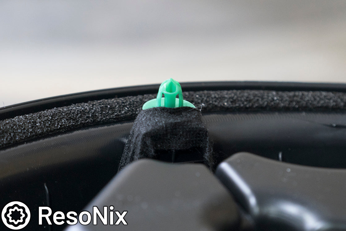 ResoNix Sound Solutions Interior OEM Audi VW Tesa tape being used to hold a door trim panel clip in place to reduce buzzing and rattling