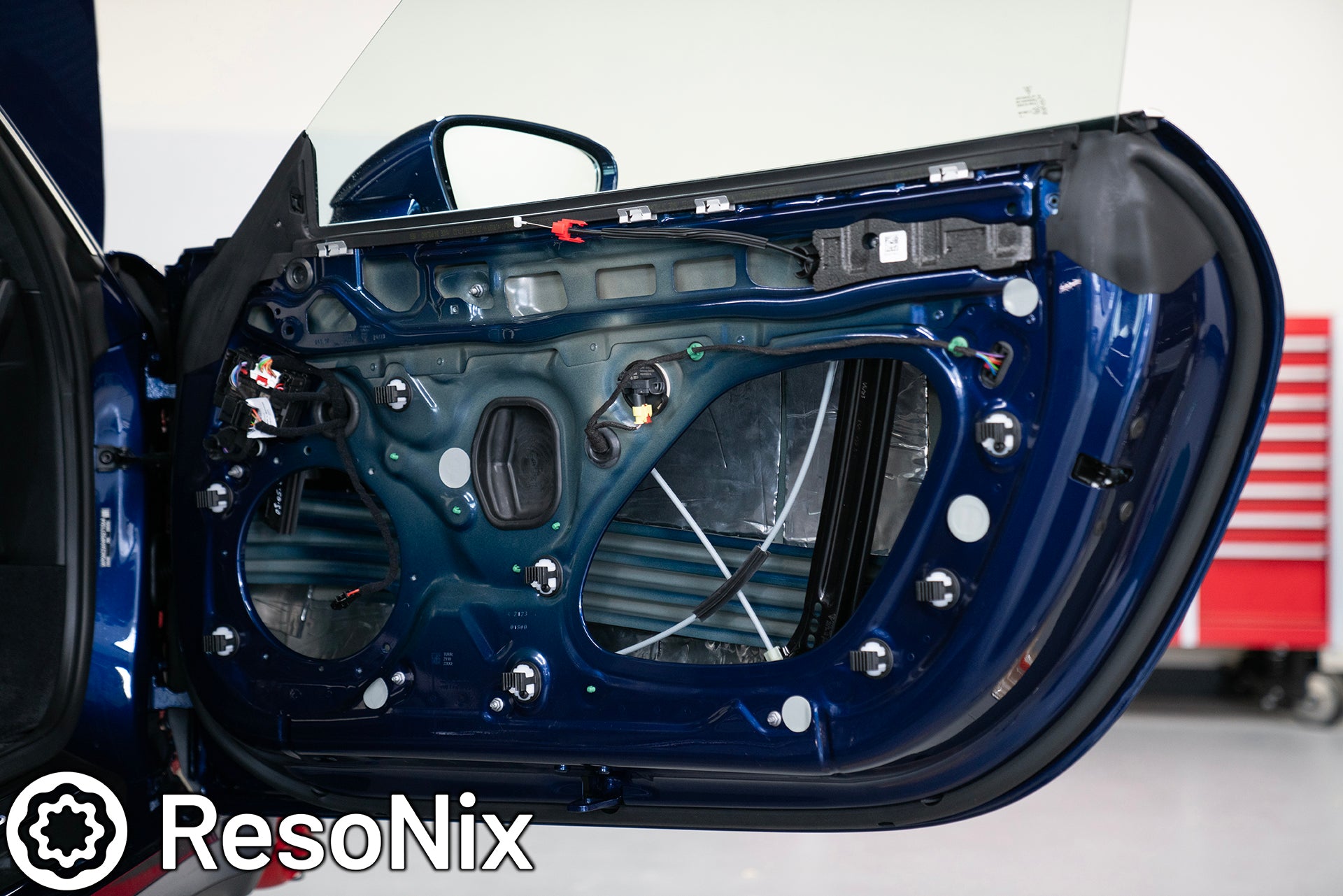 ResoNix Sound Solutions Mega CLD Squares sound deadening material installed into the door of a Porsche 911 to reduce distortion from the audio system and reduce resonance, outside wind noise, and tire noise