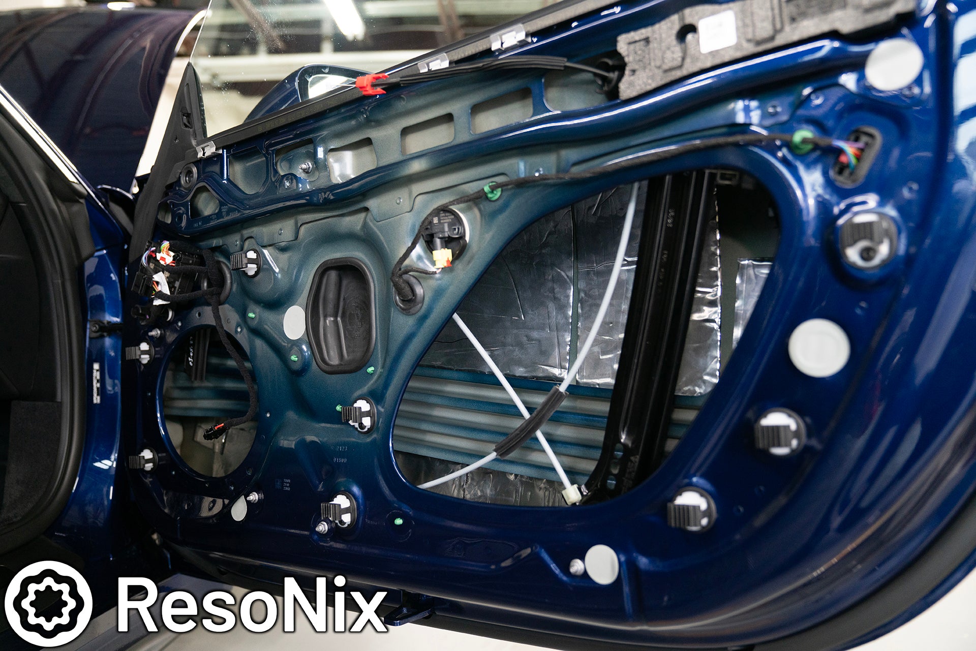 ResoNix Sound Solutions Mega CLD Squares sound deadening material installed into the door of a Porsche 911 to reduce distortion from the audio system and reduce resonance, outside wind noise, and tire noise