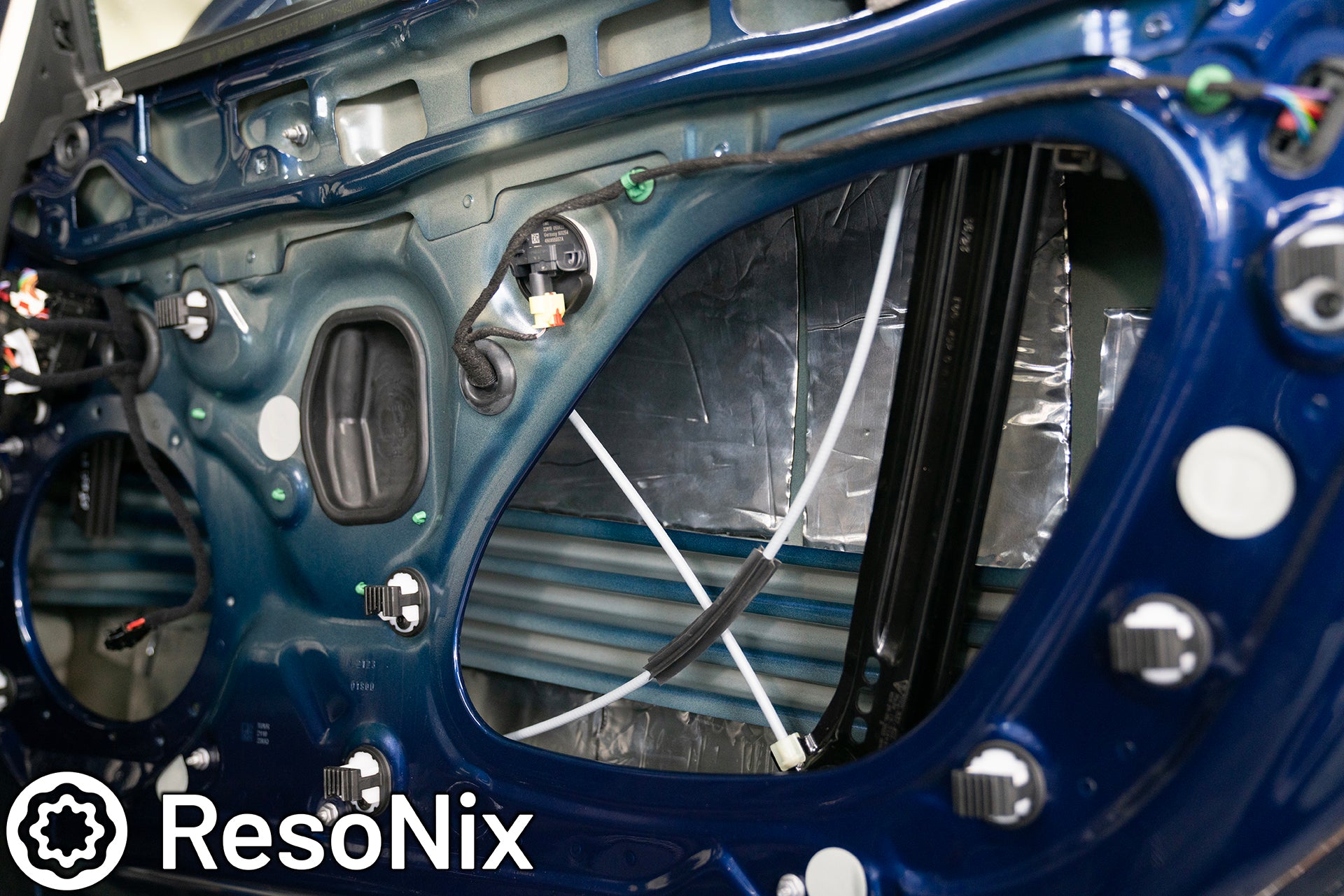 ResoNix Sound Solutions Mega CLD Squares sound deadening material installed into the door of a Porsche 911 to reduce distortion from the audio system and reduce resonance, outside wind noise, and tire noise