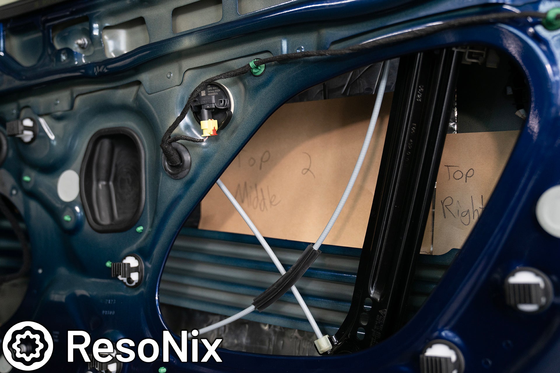 ResoNix Sound Solutions Mega CLD Squares sound deadening material installed into the door of a Porsche 911 to reduce distortion from the audio system and reduce resonance, outside wind noise, and tire noise