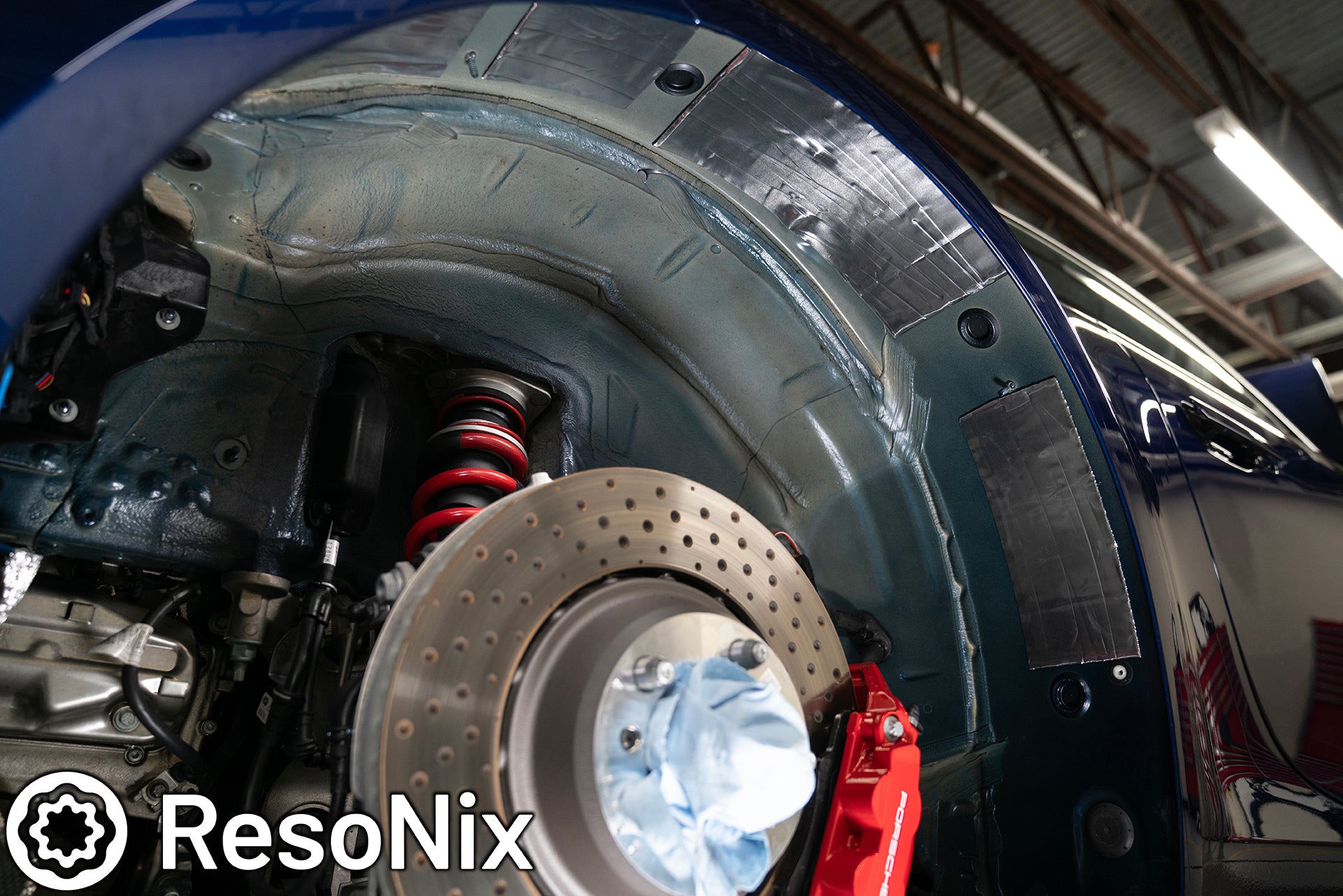 ResoNix Sound Solutions CLD Squares sound deadening material installed onto the rear outer wheel well of a Porsche 992 911 GT3 to reduce tire, road, and rock ping noise