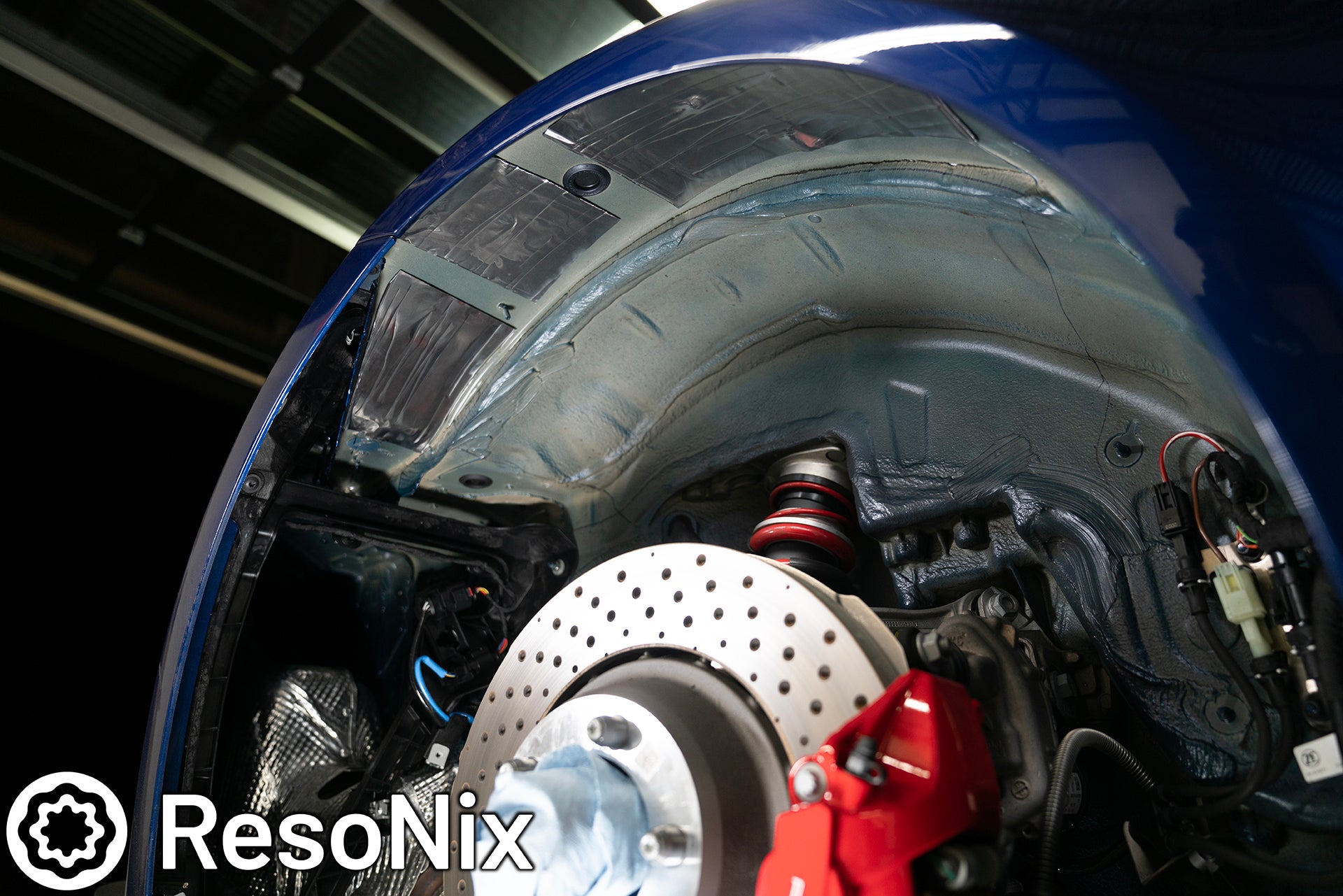 ResoNix Sound Solutions CLD Squares sound deadening material installed onto the rear outer wheel well of a Porsche 992 911 GT3 to reduce tire, road, and rock ping noise